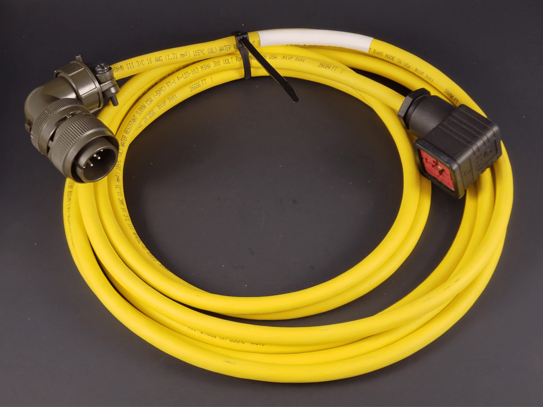 Yellow heavy-duty electrical cable with connectors for high-voltage applications, showcasing durability and safety features. Ideal for industrial use.