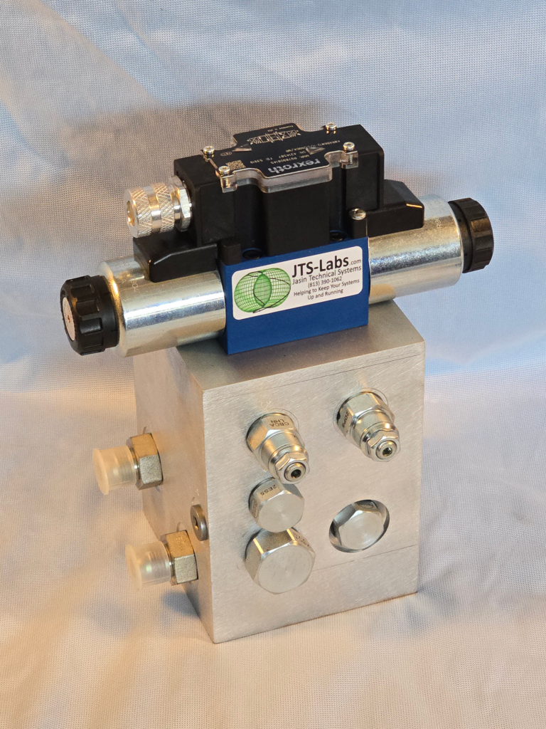 A detailed control valve assembly featuring a black and blue actuator atop a metallic block with multiple connection ports. Designed for industrial applications.